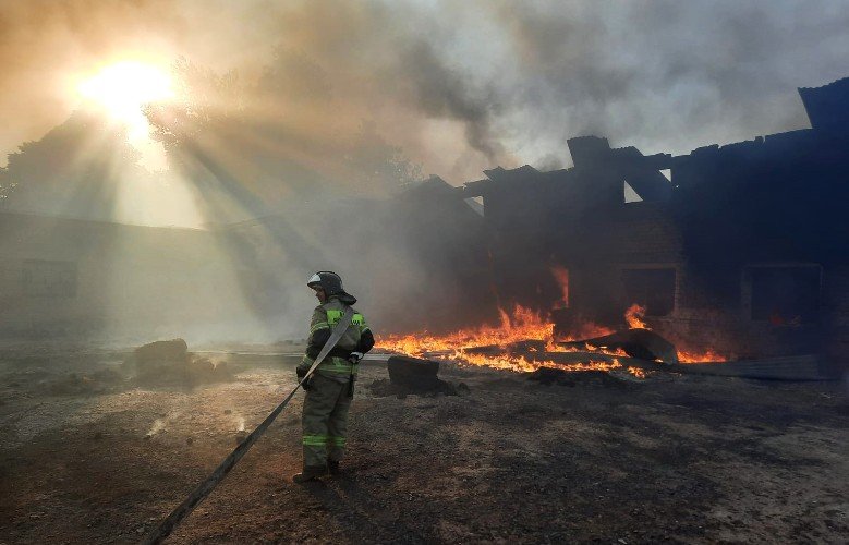 пожарный тушит огонь