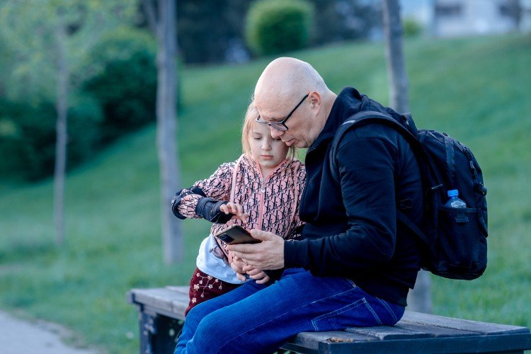 Девочка показывает папе, как установить VPN на телефон