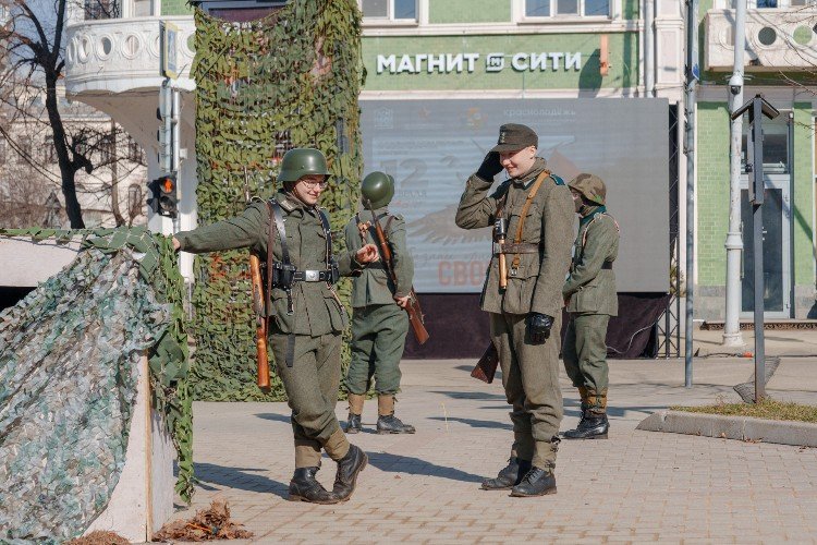 Мужчины в форме немецких фашистских солдат стоят в центре Краснодара