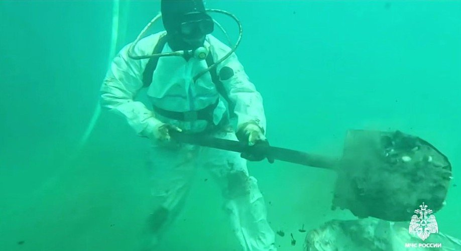 Водолаз собирает мазут