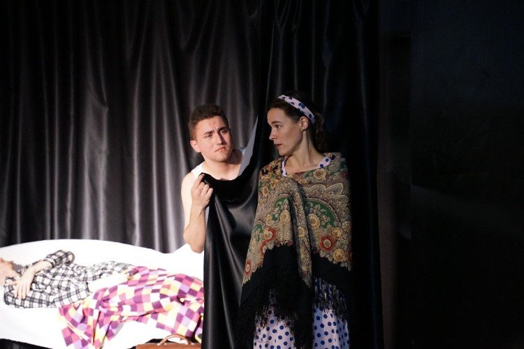 Юноша укрывает девушку на сцене театра