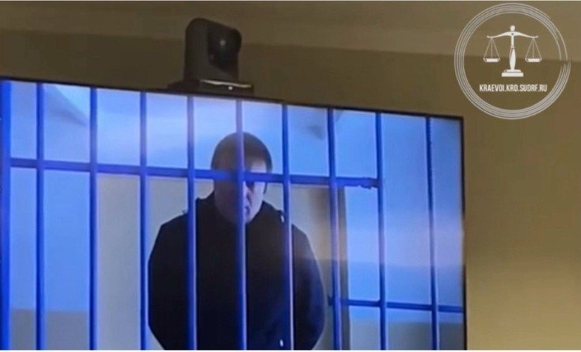 мужчина стоит за решеткой