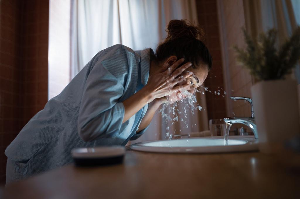 young-woman-cleaning-her-face-with-water-in-the-bathroom.jpg