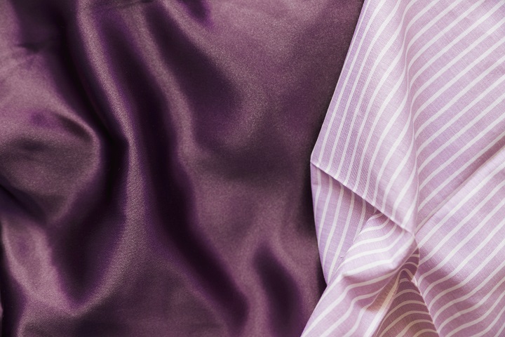 high-angle-view-pink-line-pattern-plain-purple-textile.jpg