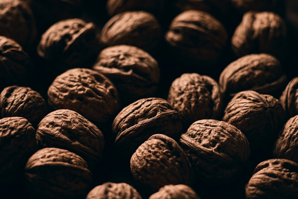 closeup-selective-focus-shot-delicious-fresh-walnuts-wooden-surface.jpg