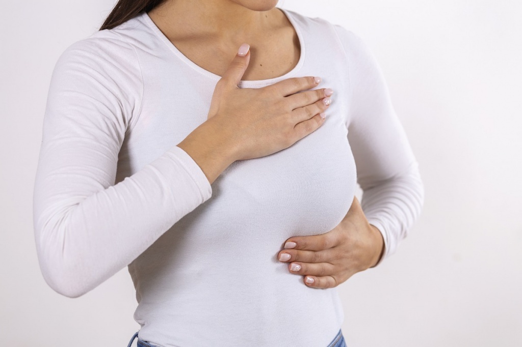woman-hand-checking-lumps-her-breast-signs-breast-cancer-gray-background-healthcare-concept-closeup-woman-s-hand-breast-showing-cancer-symptom.jpg