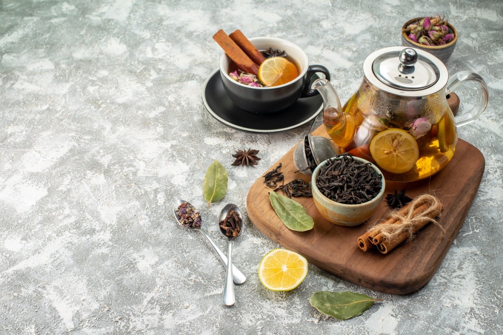 front-view-lemon-tea-cup-kettle-white-background-flower-ceremony-food-color-morning-flavor-fruit-breakfast.jpg