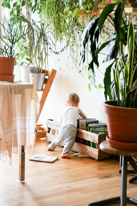 brina-blum-d-RwmHvHPPg-unsplash.jpg Маленький ребенок смотрит книжки в комнате